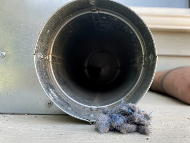 Willowick Dryer Vent Cleaning technician using specialized equipment to clear severe dryer vent blockage in Willowick